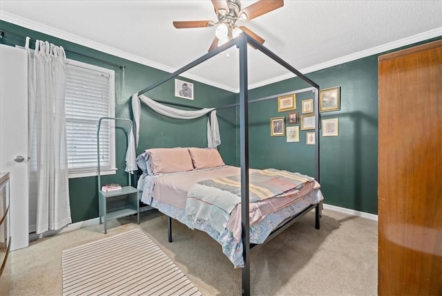 carpeted bedroom with crown molding, a ceiling fan, and baseboards
