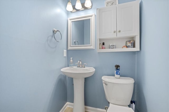 half bath featuring a sink and toilet