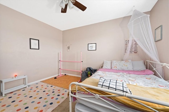 bedroom with baseboards, carpet flooring, and a ceiling fan