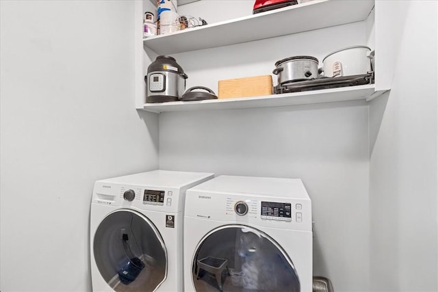 clothes washing area featuring laundry area and washing machine and dryer