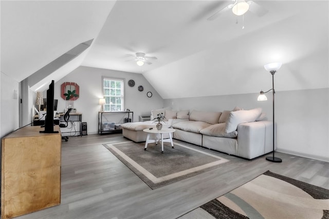 living area with ceiling fan, wood finished floors, and lofted ceiling