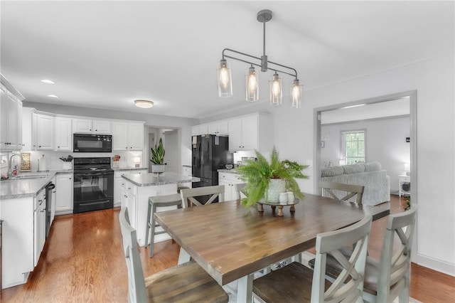 dining space with recessed lighting and wood finished floors