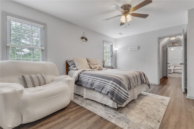 bedroom with baseboards, ceiling fan, and wood finished floors
