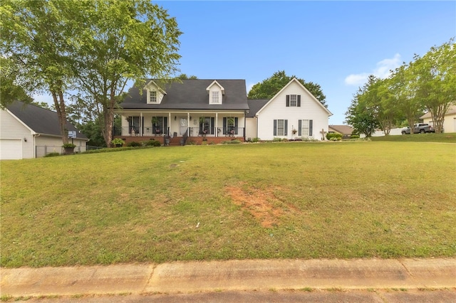 new england style home featuring a garage, covered porch, and a front lawn