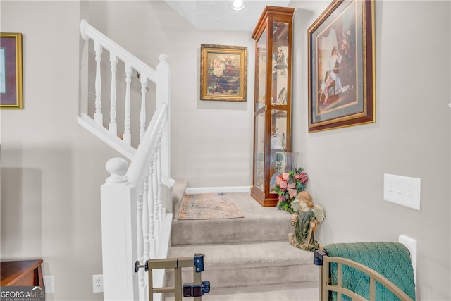 staircase featuring baseboards