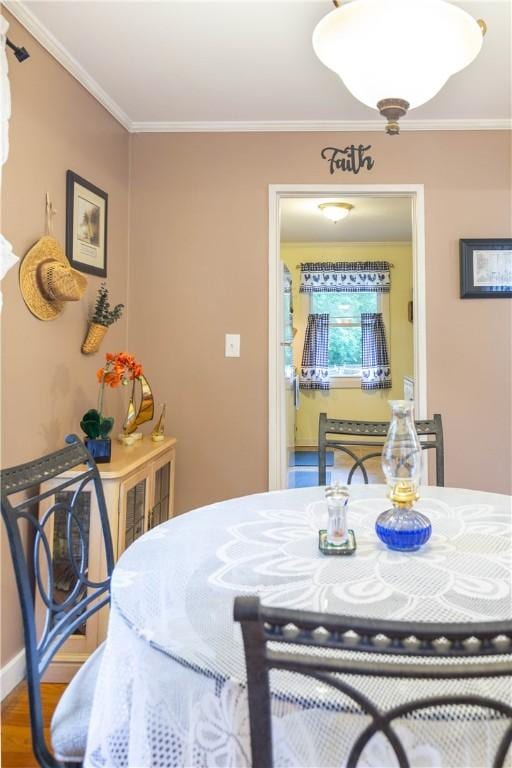 dining room featuring ornamental molding and wood finished floors