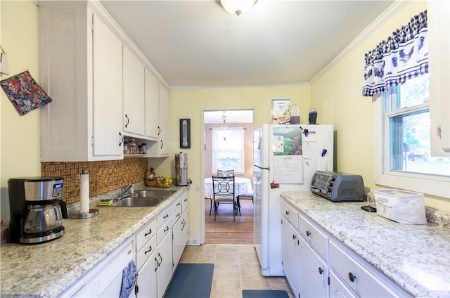 kitchen featuring a sink, light countertops, white cabinets, and a toaster