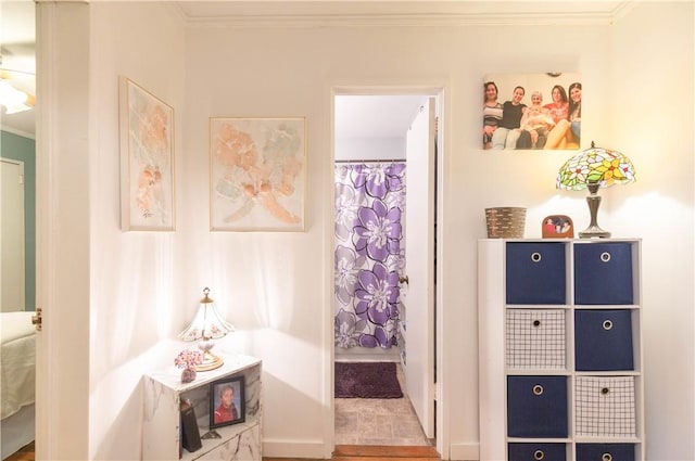 bathroom with crown molding, wood finished floors, and a shower with shower curtain