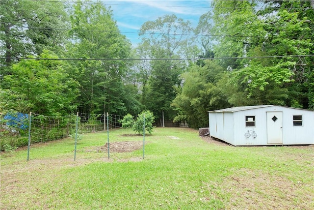 view of yard featuring a storage unit and an outbuilding