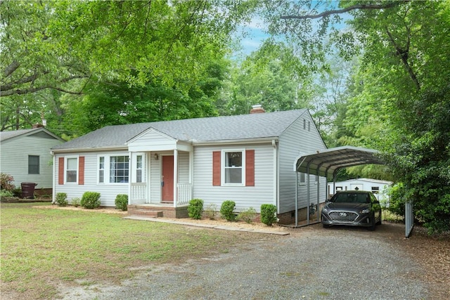 ranch-style home featuring a shingled roof, dirt driveway, a front yard, a chimney, and a carport