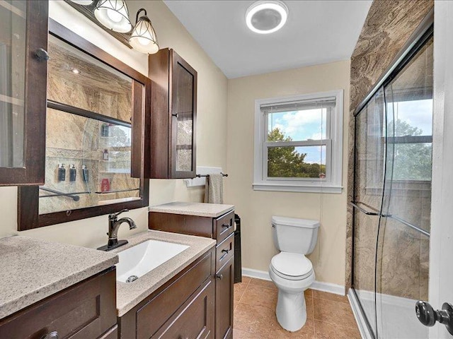 415 Van Martin Rd, Anderson, SC 29621 - bathroom with a stall shower, vanity, tile patterned floors, baseboards, and toilet