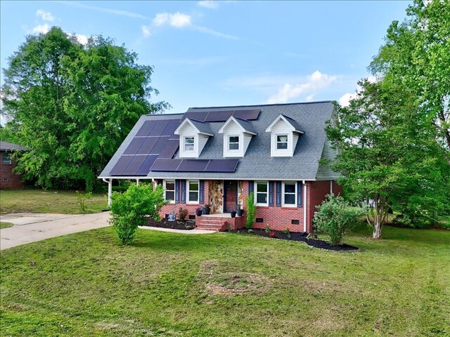 415 Van Martin Rd, Anderson, SC 29621 - cape cod home featuring roof mounted solar panels, a front yard, crawl space, and brick siding