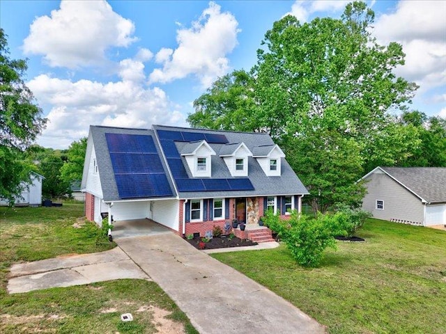 415 Van Martin Rd, Anderson, SC 29621 - cape cod-style house featuring a front yard, an attached carport, concrete driveway, a porch, and solar panels