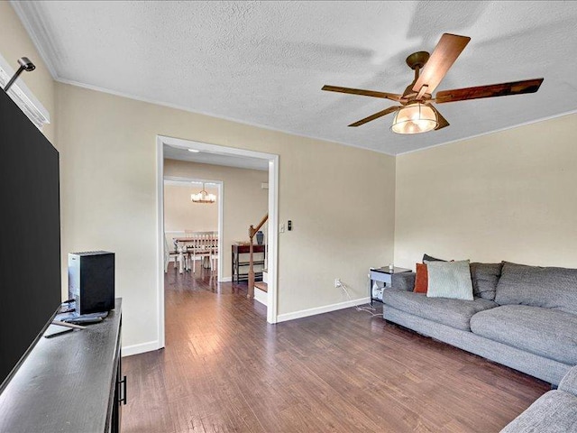 415 Van Martin Rd, Anderson, SC 29621 - living room with crown molding, baseboards, dark wood-style floors, a textured ceiling, and ceiling fan with notable chandelier