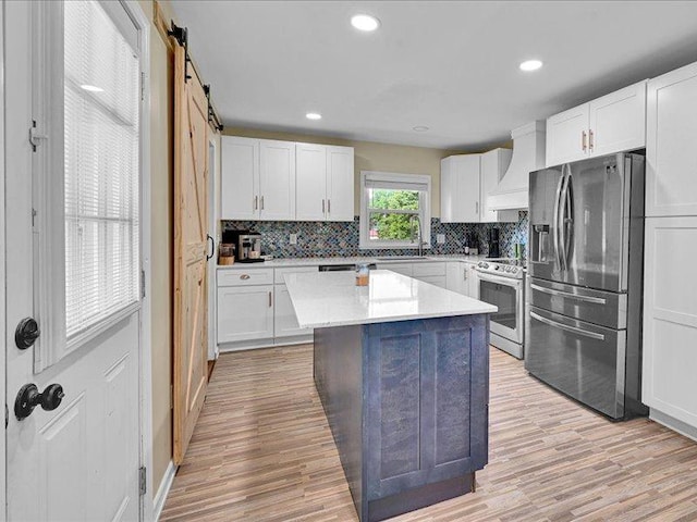 415 Van Martin Rd, Anderson, SC 29621 - kitchen featuring white cabinetry, light wood-style floors, appliances with stainless steel finishes, and tasteful backsplash