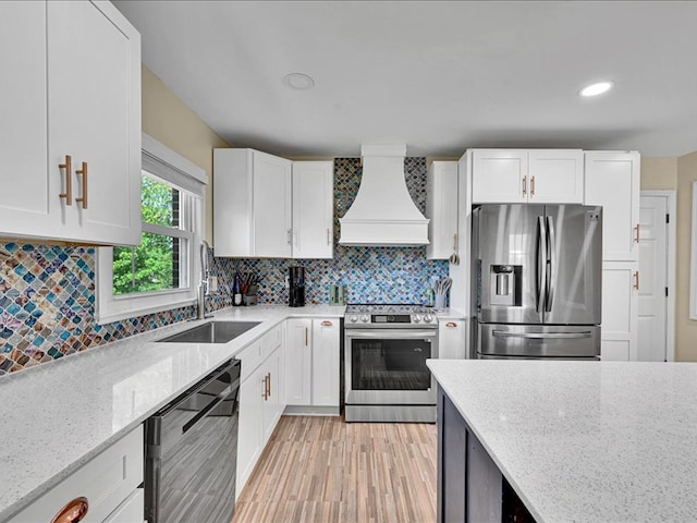 415 Van Martin Rd, Anderson, SC 29621 - kitchen with appliances with stainless steel finishes, light stone counters, a sink, premium range hood, and white cabinetry