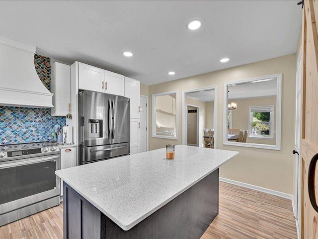 415 Van Martin Rd, Anderson, SC 29621 - kitchen with baseboards, white cabinets, custom range hood, backsplash, and stainless steel appliances