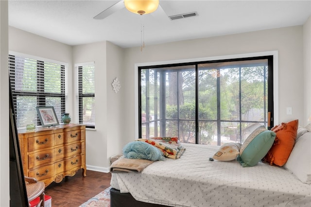 bedroom featuring visible vents, dark wood finished floors, baseboards, and multiple windows