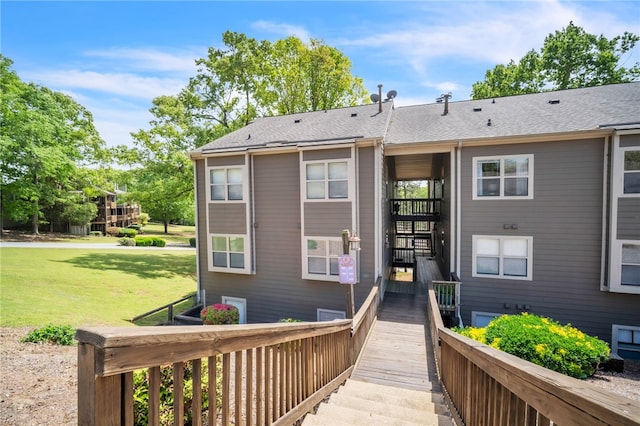 back of property with a lawn