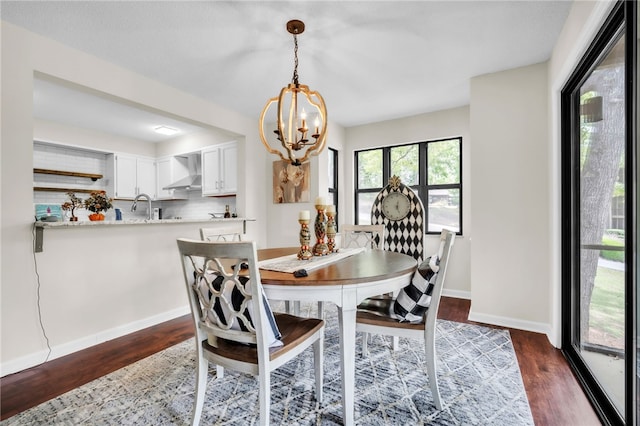 dining room with an inviting chandelier, dark wood finished floors, and baseboards