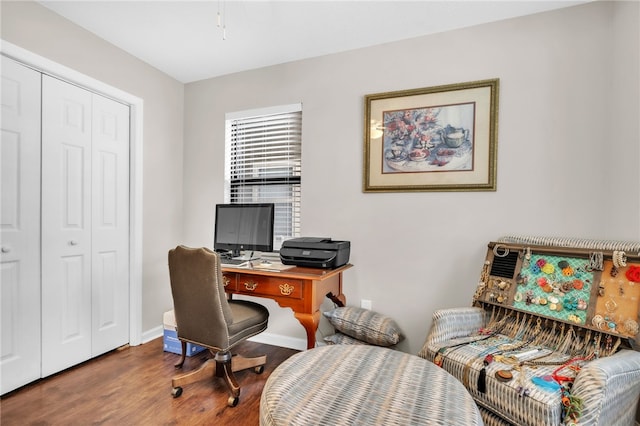 office space with baseboards and wood finished floors