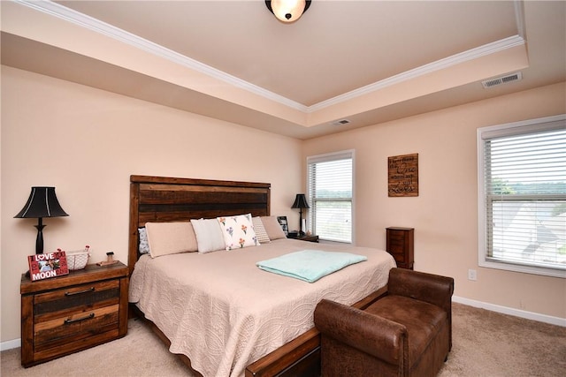 bedroom with a raised ceiling, carpet, baseboards, visible vents, and ornamental molding
