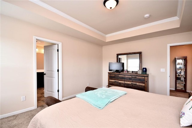 carpeted bedroom with crown molding, baseboards, and a raised ceiling
