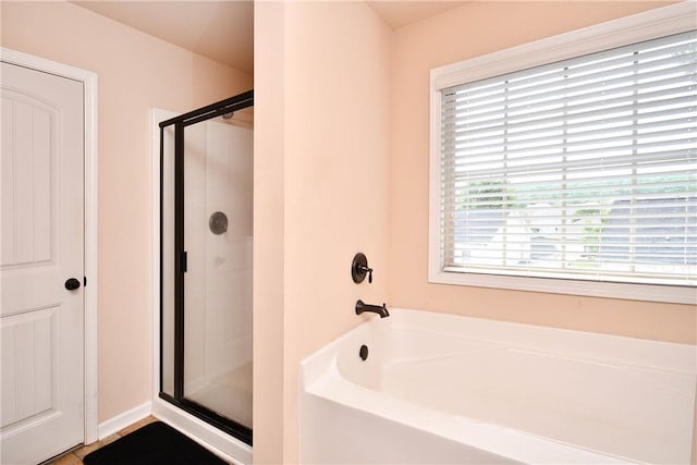 bathroom featuring a garden tub and a stall shower