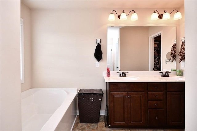 full bath featuring double vanity, a sink, and a bath