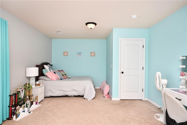 bedroom featuring baseboards and carpet