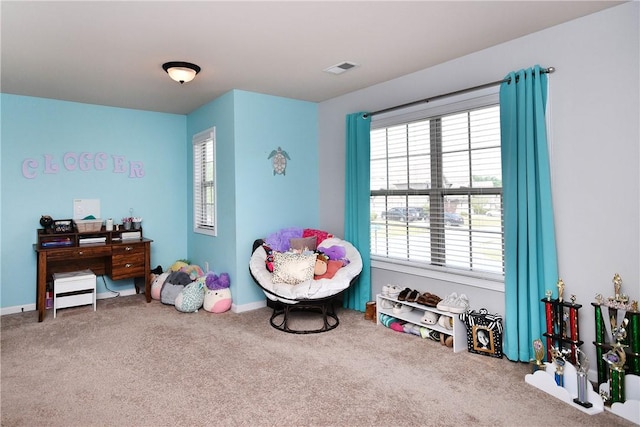 recreation room featuring carpet floors, a healthy amount of sunlight, and visible vents