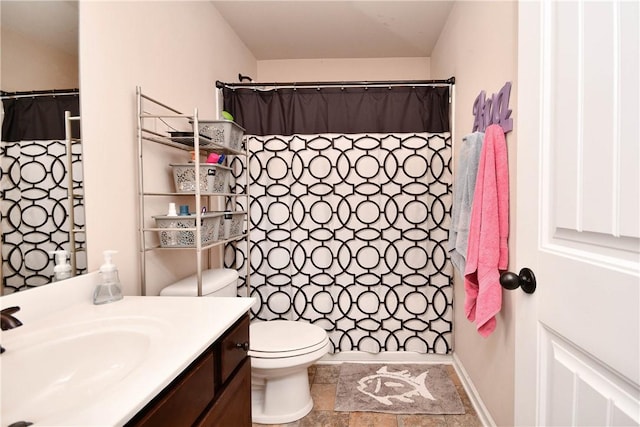 bathroom with vanity, a shower with shower curtain, and toilet