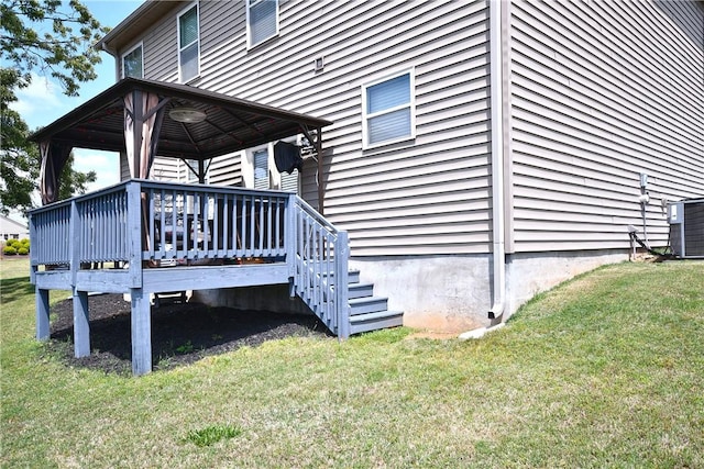 property entrance with a lawn, a wooden deck, and central air condition unit
