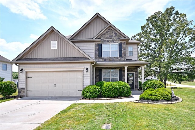 craftsman house with board and batten siding, a front lawn, concrete driveway, an attached garage, and stone siding