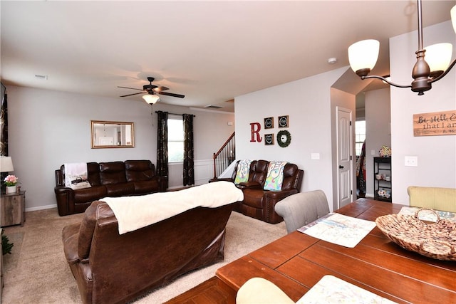 living room featuring visible vents, arched walkways, ceiling fan, and stairway