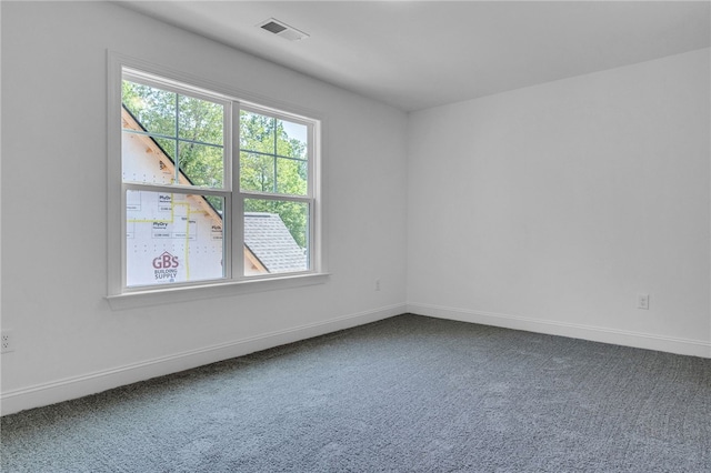 carpeted empty room with baseboards and visible vents