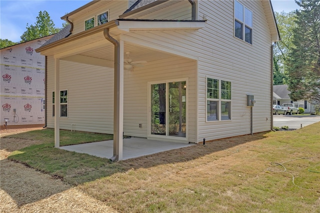 back of property featuring a yard and a patio area