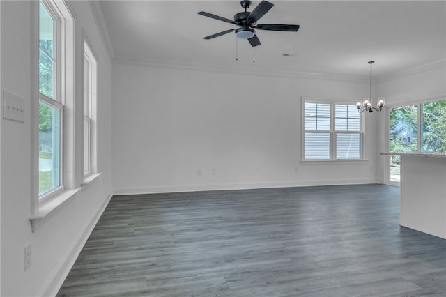 spare room featuring baseboards, ornamental molding, ceiling fan with notable chandelier, and dark wood-style flooring