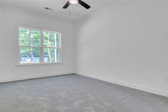 unfurnished room featuring carpet flooring, crown molding, ceiling fan, baseboards, and visible vents