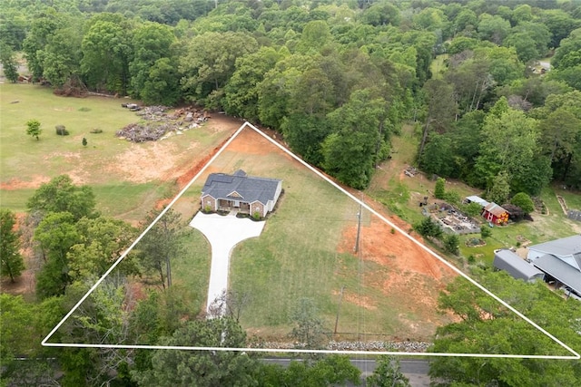 drone / aerial view with a wooded view