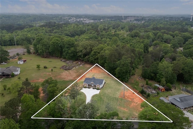 drone / aerial view with a wooded view