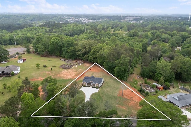 birds eye view of property featuring a wooded view