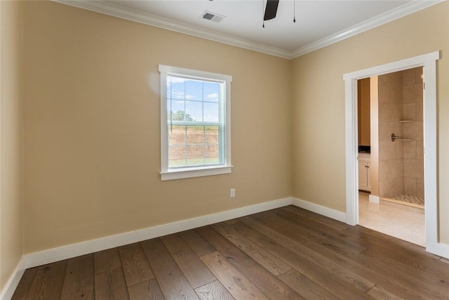 unfurnished room with crown molding, a ceiling fan, baseboards, wood finished floors, and visible vents