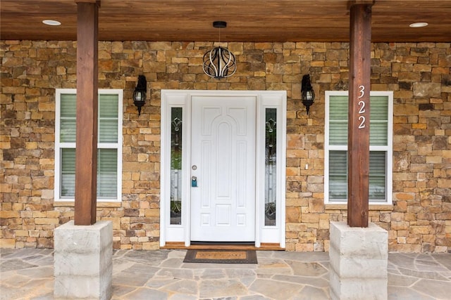 view of exterior entry featuring stone siding