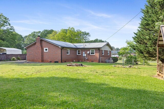 302 Jasmine Dr, Anderson, SC 29625 - back of property featuring a lawn, brick siding, fence, and a chimney