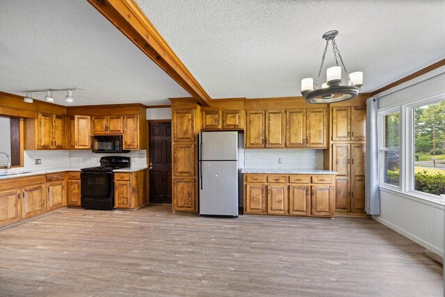 302 Jasmine Dr, Anderson, SC 29625 - kitchen with brown cabinetry, black appliances, and a textured ceiling