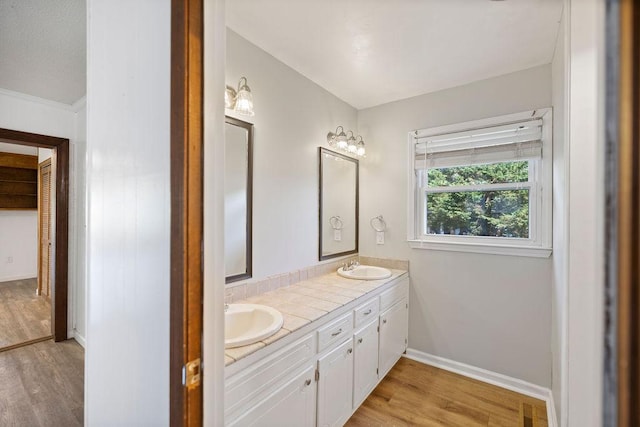 302 Jasmine Dr, Anderson, SC 29625 - full bathroom with double vanity, baseboards, a sink, and wood finished floors