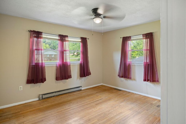 302 Jasmine Dr, Anderson, SC 29625 - unfurnished room featuring a ceiling fan, a baseboard heating unit, a wealth of natural light, and wood finished floors