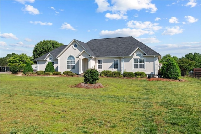 ranch-style home featuring stucco siding and a front yard