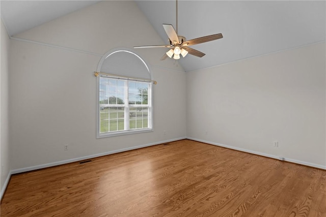 unfurnished room featuring a ceiling fan, baseboards, wood finished floors, and high vaulted ceiling